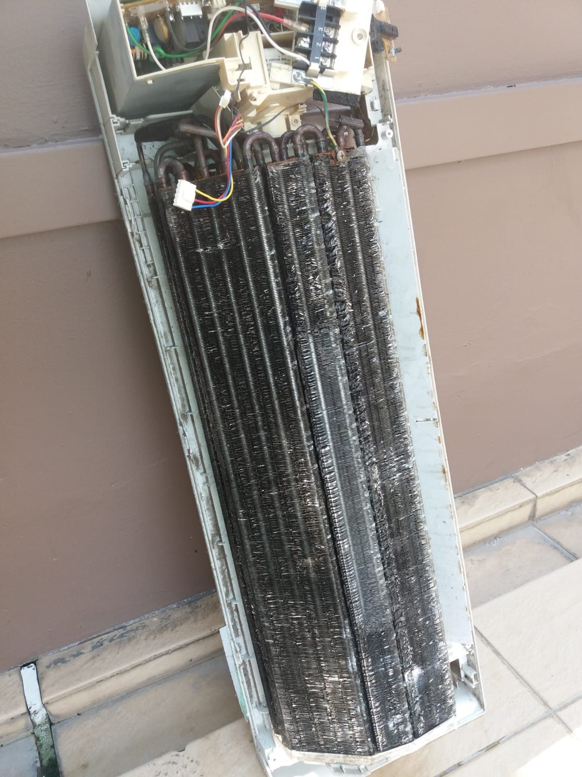 OM Aircon servicing a wall-mounted unit